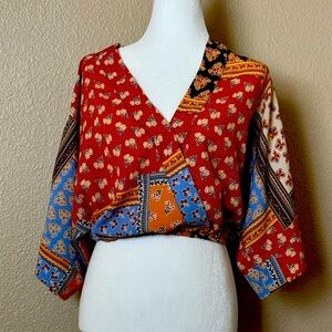 Vintage inspired, snap at v-neckline, and cinched waist top!  Fun and trendy!